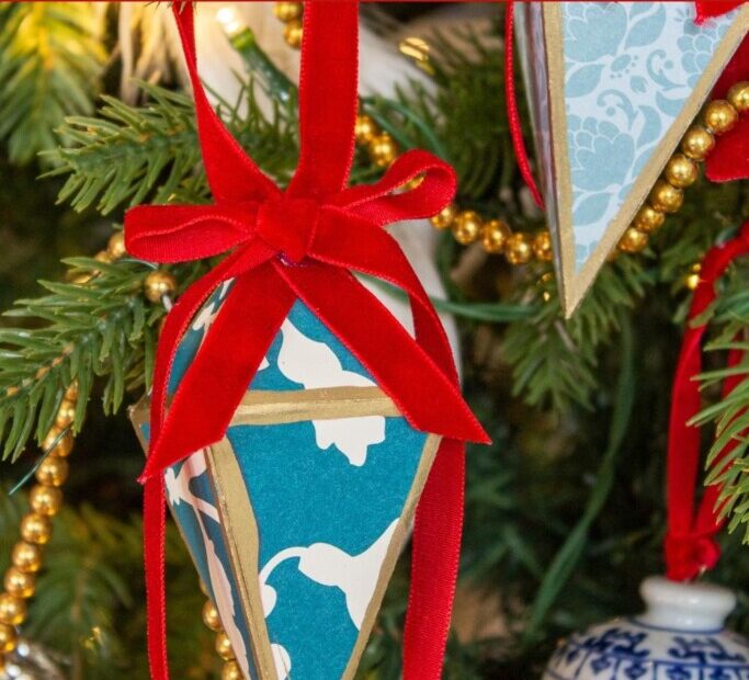 blue and white 3d paper Cricut Christmas ornament on a tree