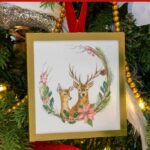 Christmas watercolor ar of two deer on a Christmas ornament