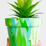 Terracotta flower pot decorated with paint pouring