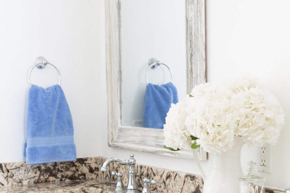 sky blue towels in towel ring in neutral color bathroom.