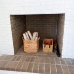 fireplace wood storage built into a brick wall in a living room