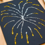 Silver and gold metallic fireworks art made with glue and glitter