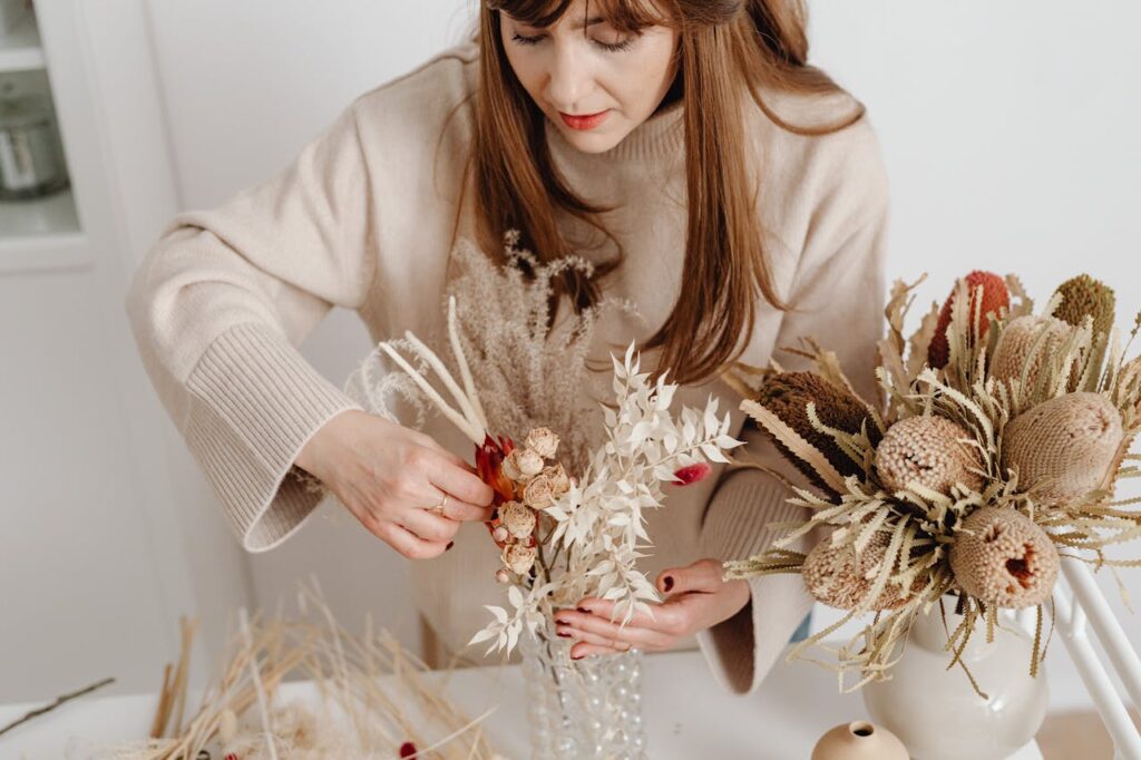 pexels-photo-6641321 A Florist Arranging Dried Flowers in a Vase